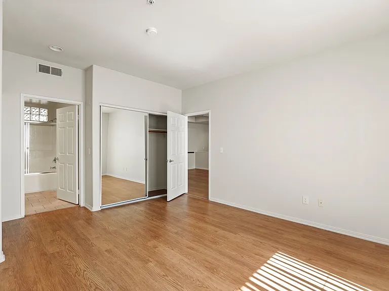 Bedroom with Two Closets, Bathroom, and Vinyl Flooring