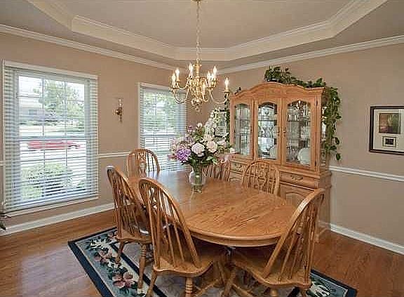 Dining Room with tray ceiling and crown molding