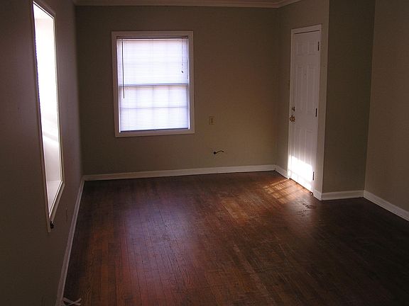 Front door and living/bedroom space.