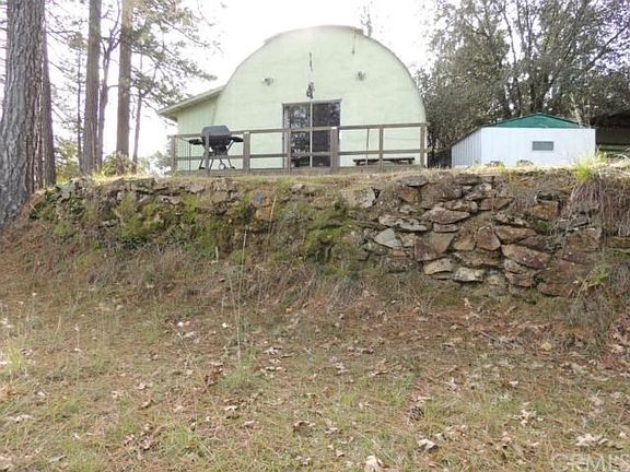 Rear of Home as seem from Horseshoe pit area, with rock retaining wall