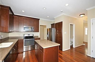Entertain in your gourmet kitchen, Corian counter tops, all stainless appliances included, new fixtures, large pantry, hardwood flooring. Kitchen opens to your lovely family room.   This MOVE IN READY home awaits you.