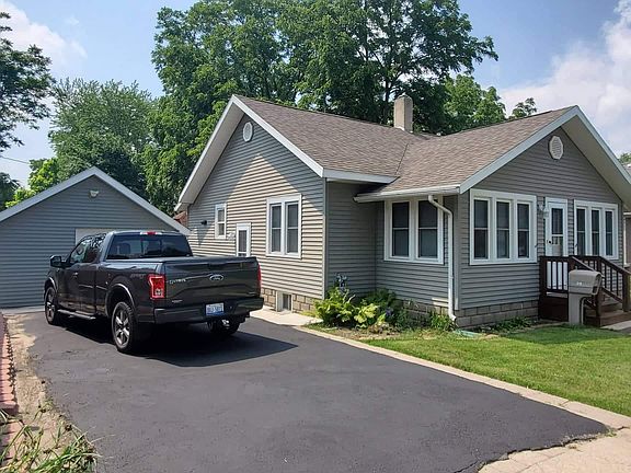 Blacktop driveway to garage and side door entrance.