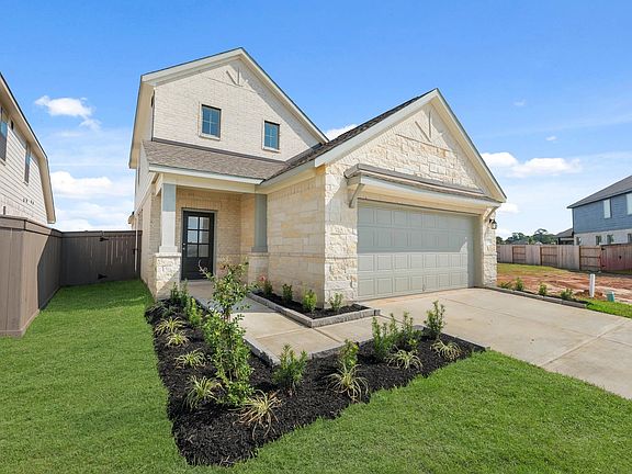 Charming front entry framed with greenery.