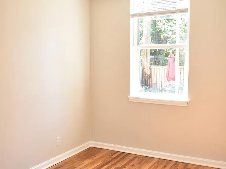 Bedroom overlooks parking lot.