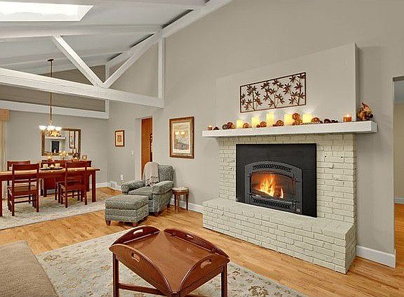 Living room with hw flooring, vaulted & exposed beams, skylight, fireplace