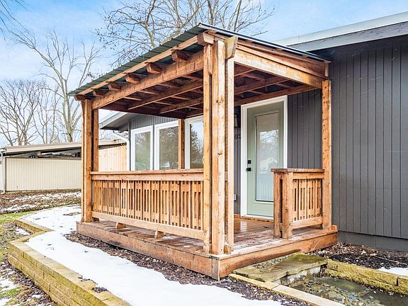 Front Entry: Covered Front Porch, Raised Beds full of Hostas Spring-Fall