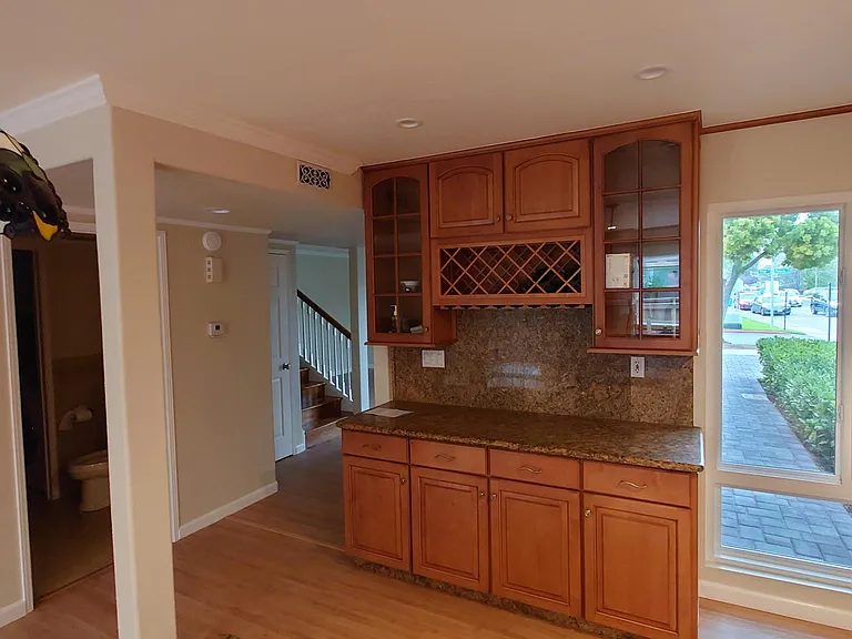 Wine Bar and powder room entry, with access to a separate laundry room.
