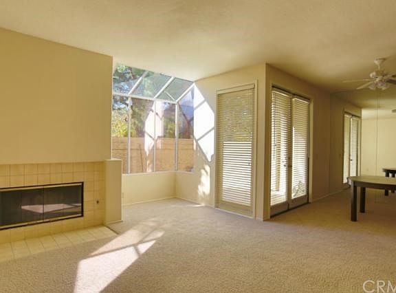 This picture if from the corner of the living room showing the fireplace, garden window and the mirrored wall in the dining room