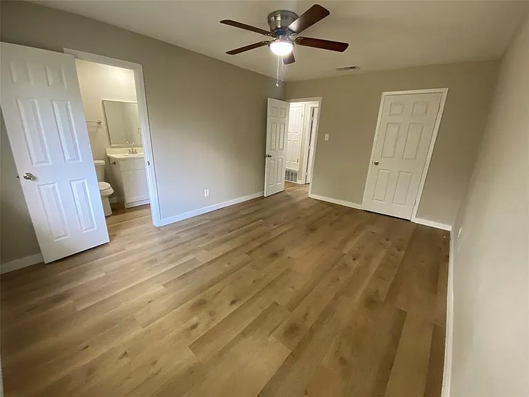Primary Bedroom showing private bath, entry and closet