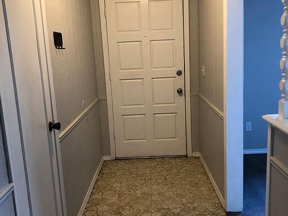Looking at front door entry, tiled floor. Formal living/dining to right, coat closet to left.
