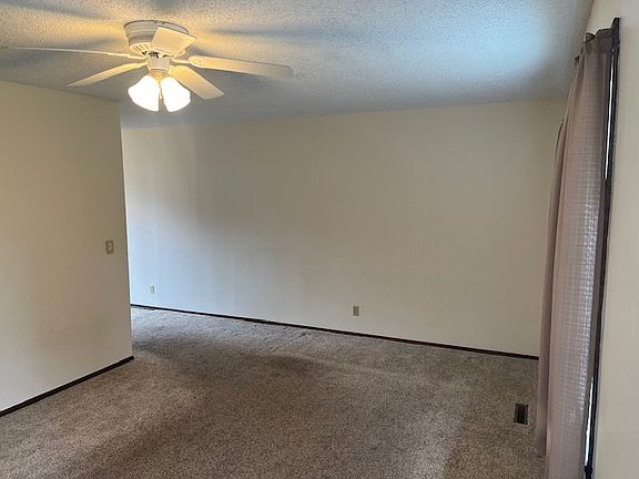 Living room leading into dining and kitchen