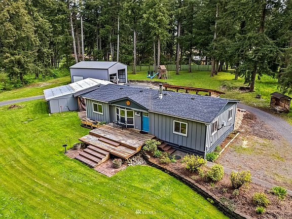 Aerial photo of the home and shop/garage areas from a different angle.  Notice how big the back yard is also.