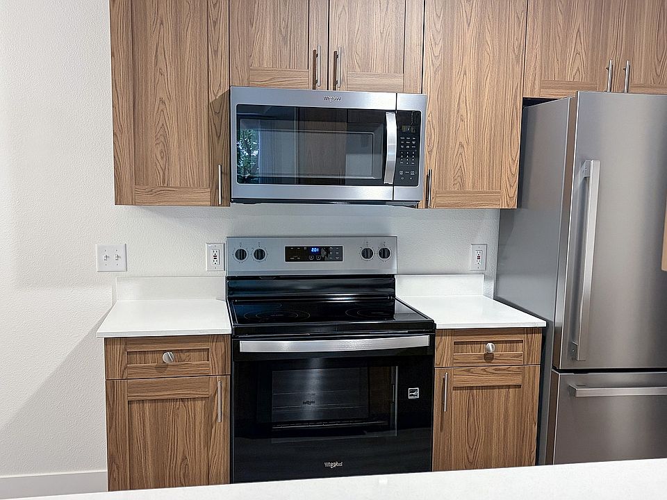 Modern stainless steel appliances paired with warm cabinetry create a kitchen you'll love coming home to.