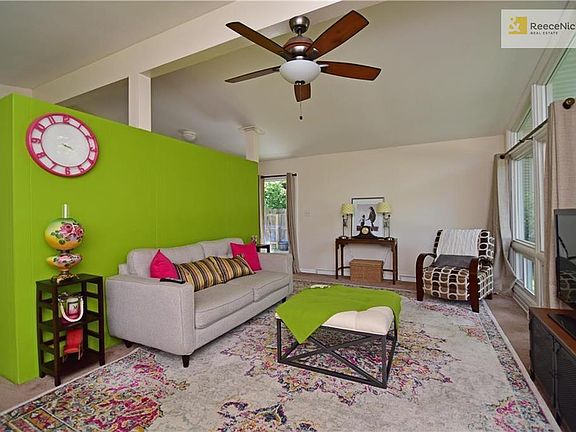 Spacious living room has unique open design to dining area and kitchen