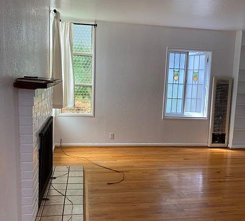 Back Unit of Home on the Strand. Living Room has Hardwood Floors