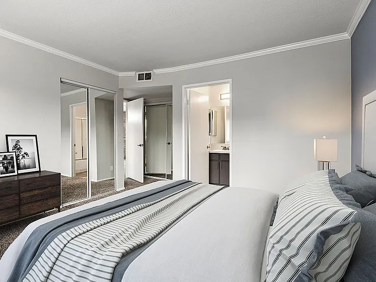 Carpeted bedroom with access to private bathroom.