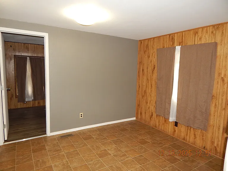 Kitchen dining area with entrance to front bedroom on the left.