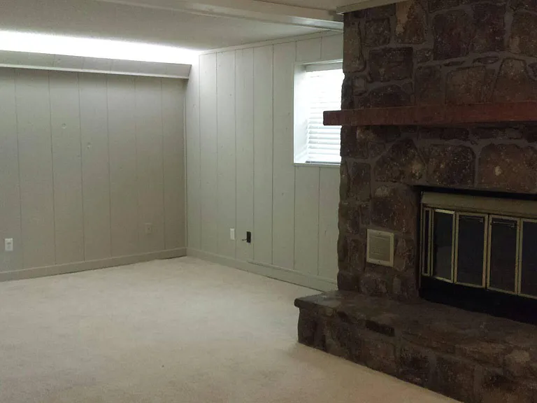 lower level living area with fireplace, connects to 3 car covered parking via mud room