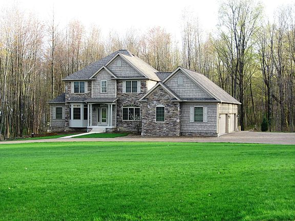 4 Car, Side-Load & Heated Garage With Basement Access