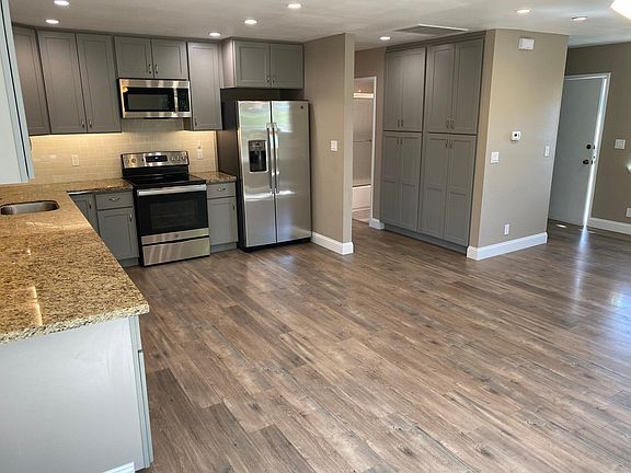 Front door view of kitchen and pantry area