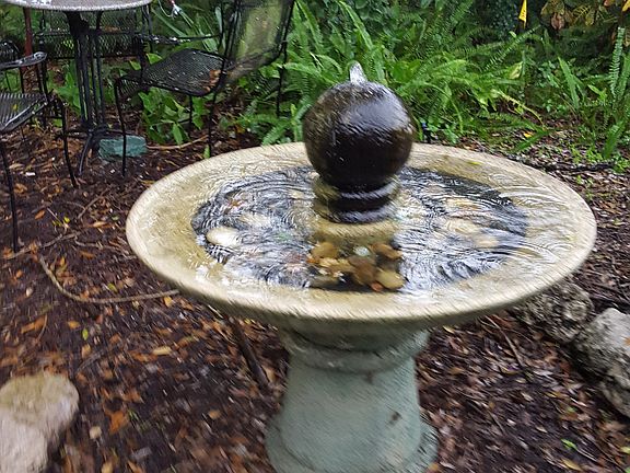 Fountain at bottom of porch stairs