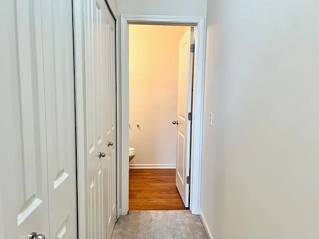 Hallway to 1/2 bath with extra storage