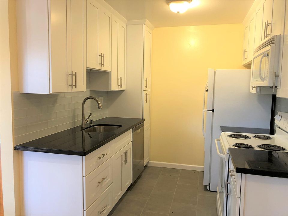 Remodeled kitchen with Shaker cabinets, quartz countertop, and European-style backsplash