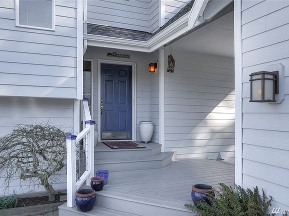 Welcoming front entry with covered breezeway from garage to front door.