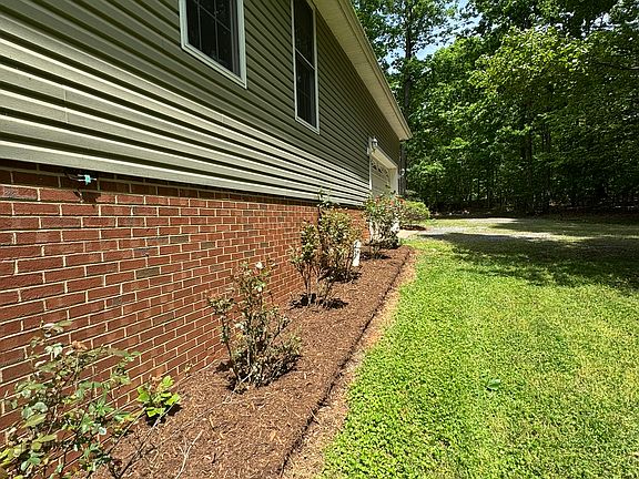 Side of home by driveway and 2-car garage