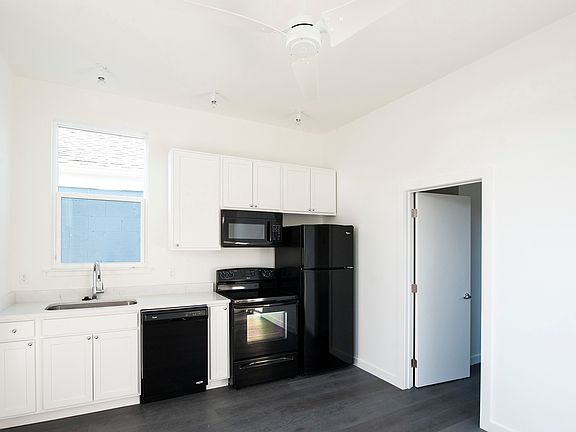 kitchen with custom cabinets, silestone countertops, dishwasher, microwave, stove/oven, refrigerator