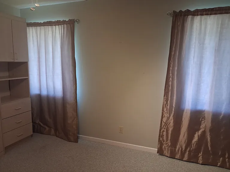 2 windows in guest bedroom overlooks pool.