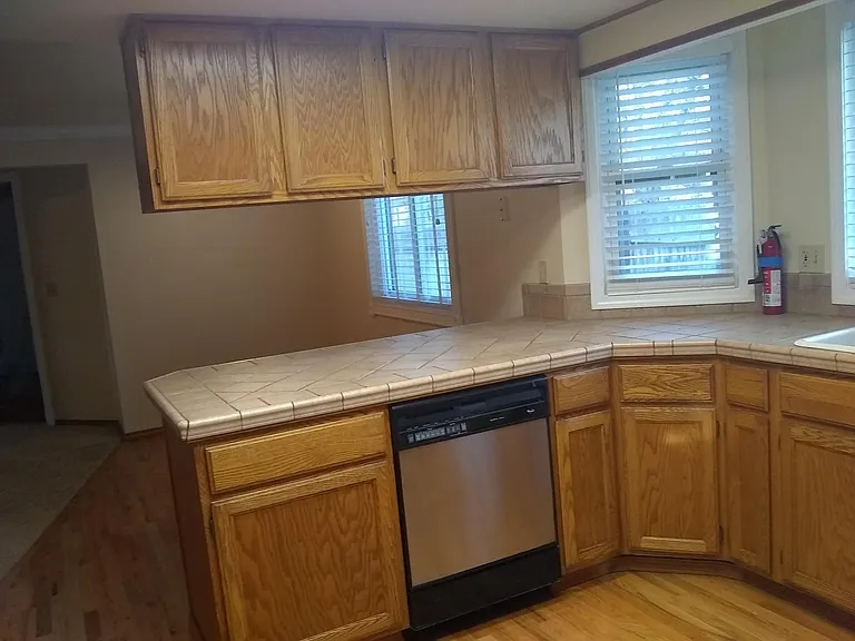 Kitchen with kitchen table area in background