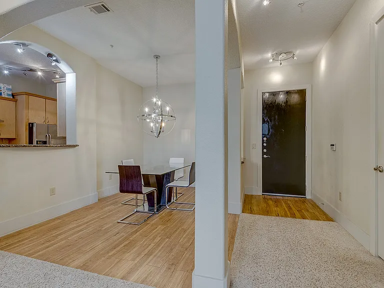 View of Dining Room, Kitchen and entrance door from the Living Room