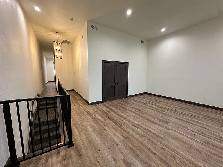 Living room with double doors to bedroom.