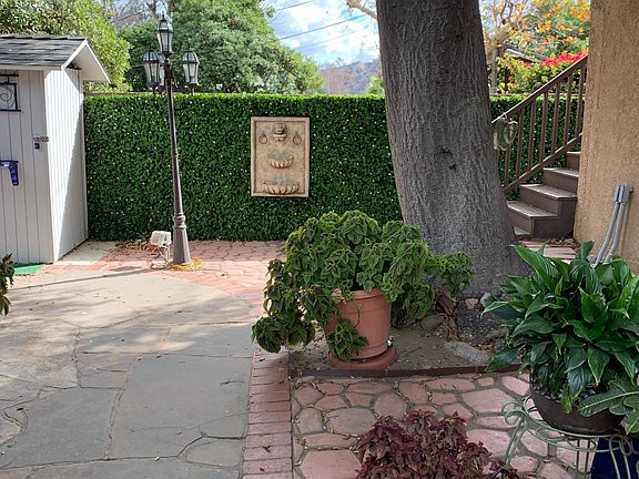 Newly landscaped / Entrance through Backyard to Stairs / Lighted at Night
