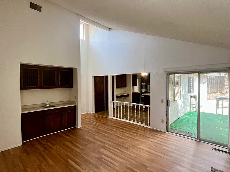 The family/entertaining room features a brick wood fireplace and a wet bar.
