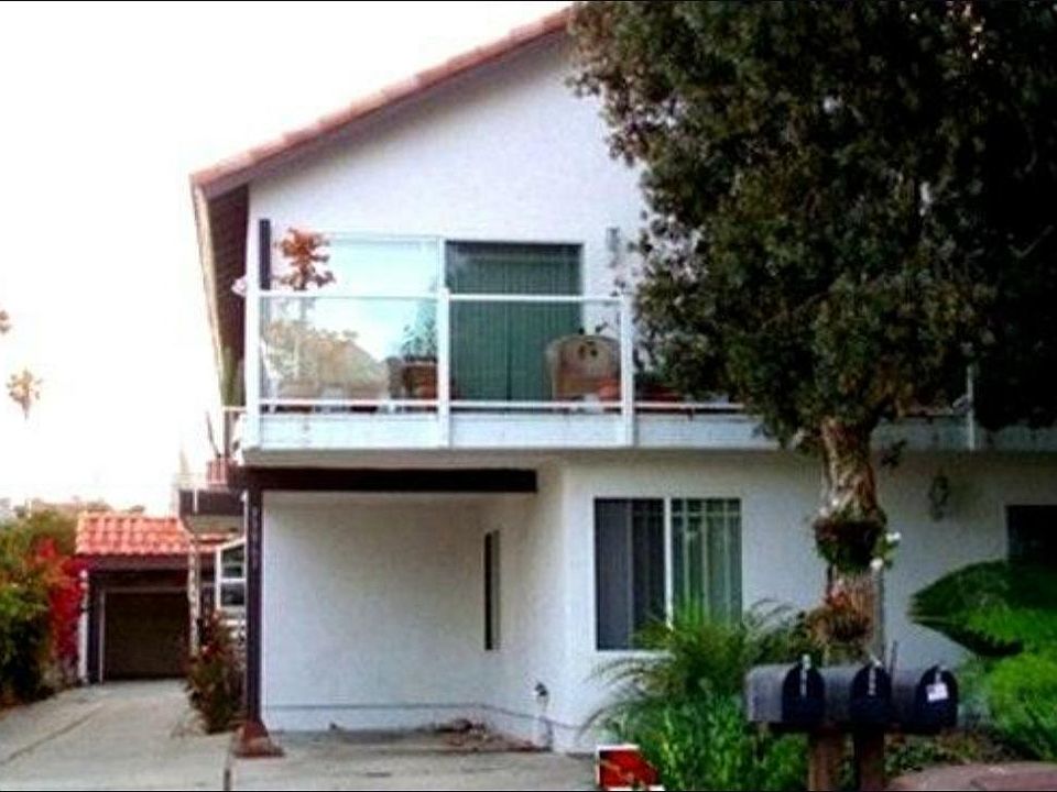 Upstairs Unit with balcony, carport and garage.