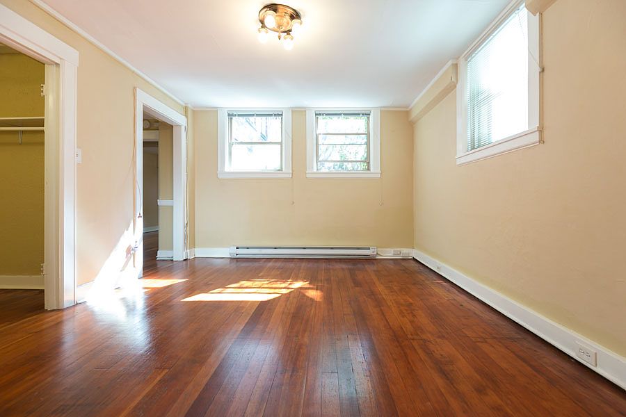Unit A, ground floor 1BR Living room with windows to greenspace