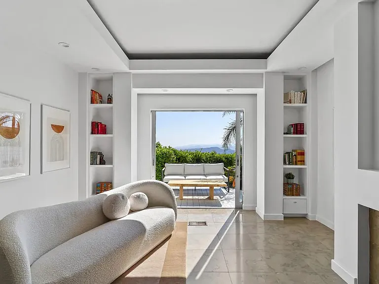 Primary bedroom features a cozy sitting area for moments of relaxation and comfort.