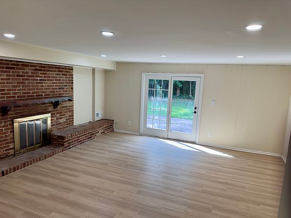 Family room with gas fireplace and door to backyard