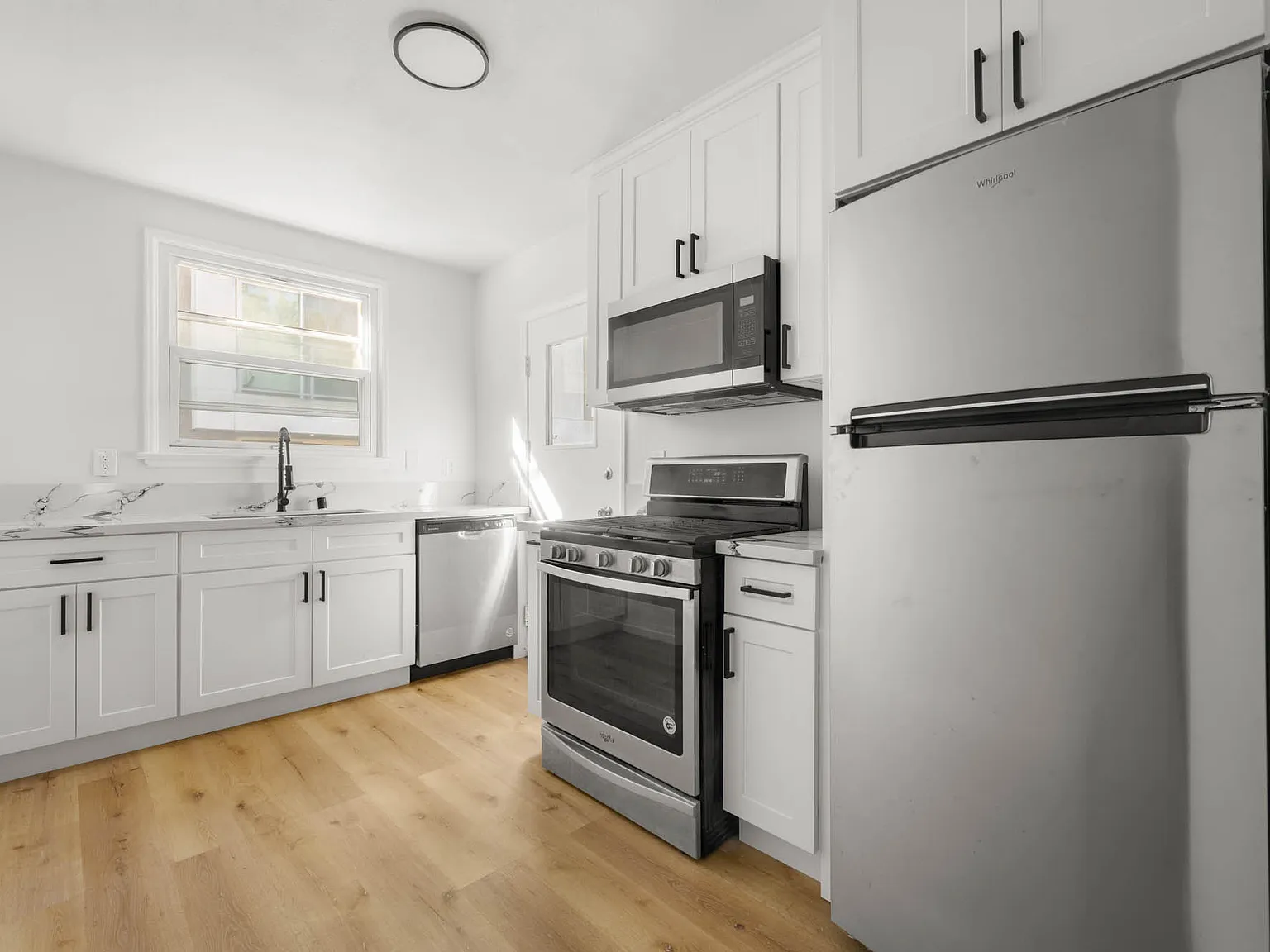 Spacious Three Bedroom with Updated Kitchen, Oversized Closets, and In-Unit Laundry ~ In The Hear... — Photo 2