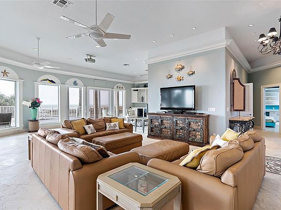 Oversized living/kitchen/dining concept has high tray ceilings & picturesque windowthat literally line the walls along the beachside decking allowing awesome unobstructed views to the Gulf.