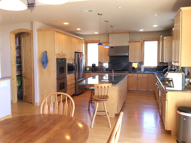 Kitchen with granite countertops, tons of storage, double ovens, and space to entertain.