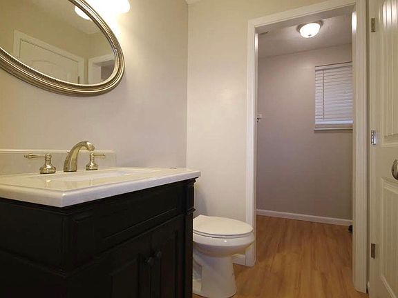 Half bath off TV room with separate laundry area