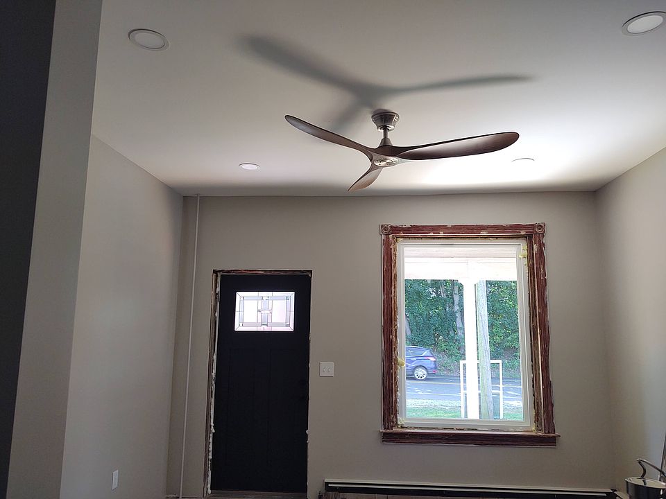 Living room looking out to street, will have real 2" wide real wood mini blinds in matt black to match door