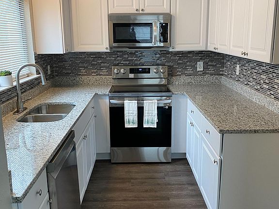 Kitchen with brand new dishwasher, microwave, and stove . Refrigerator not included