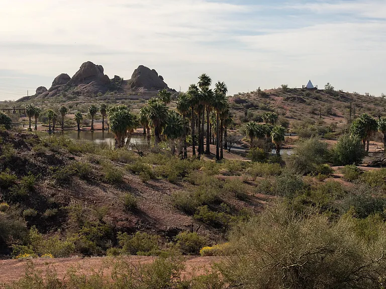 Desert trails, palm-lined waterways, and striking rock formations define the landscape surrounding Modera Rio Salado in Tempe.