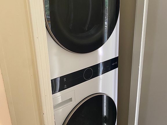 Stacked washer and dryer closet in kitchen.