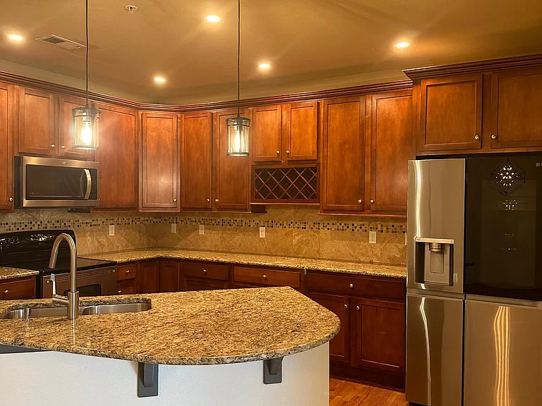 Kitchen with a modern fridge and dishwasher; Controlled lighting
