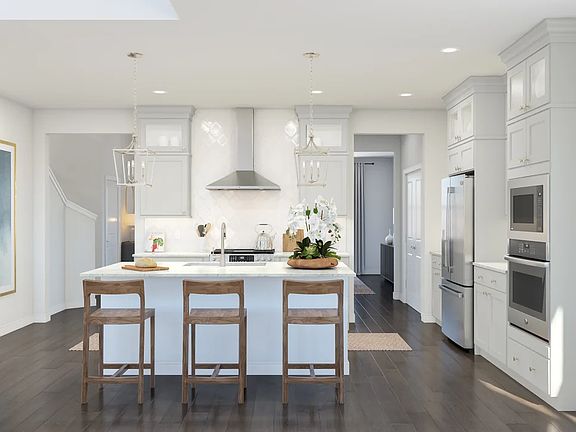 Kitchen with glass upper cabinets and pendant lighting
